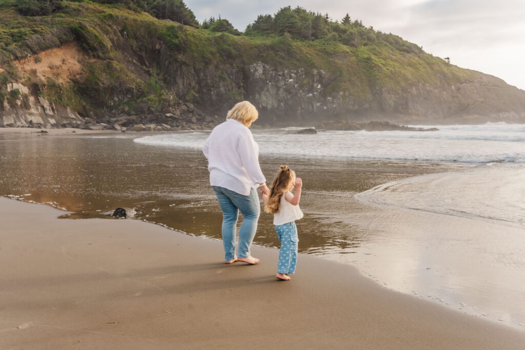  Walking along the Oregon Coast with ocean in the background and green cliff 