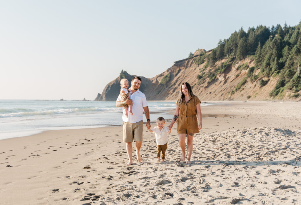 Family walking along the shoreline at Roads End Beach in Lincoln City Oregon.
