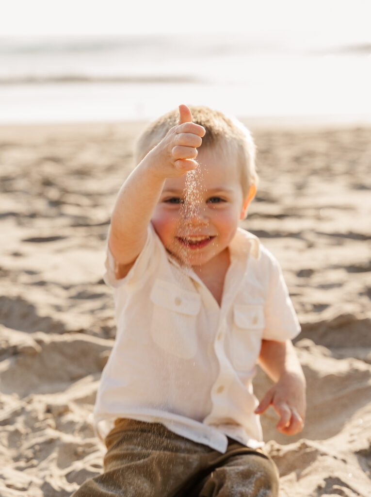 Playful family moment on the sand during a Lincoln City Oregon Coast photography session.