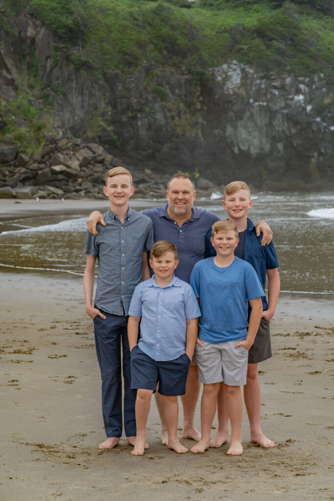 family wearing earth tone outfits during Oregon Coast beach photo session