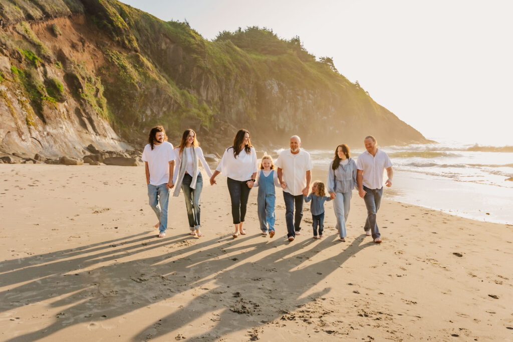 Oregon Coast family photography session with extended family walking on the beach at sunset.