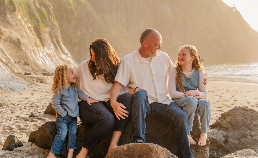 Multigenerational family photo on the Oregon Coast, grandparent and grandchild moment during a Lincoln City beach session.